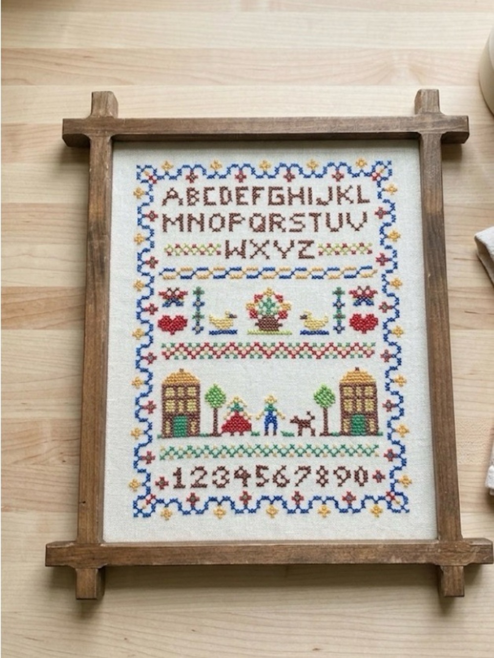 Framed Cross Stitch Sampler with Alphabet & Numbers 14“ x 17“ frame has glass.